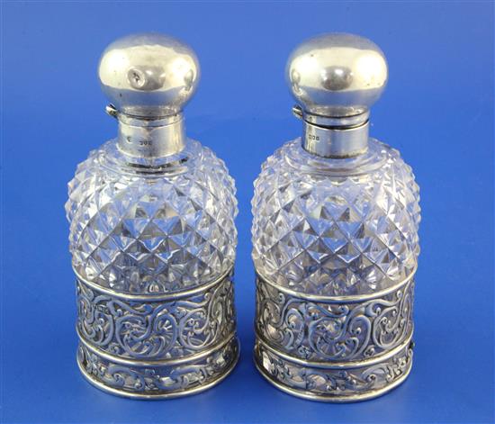 A pair of late 19th/early 20th century silver mounted hobnail cut glass scent bottles by William Hutton & Sons, 6.5in.